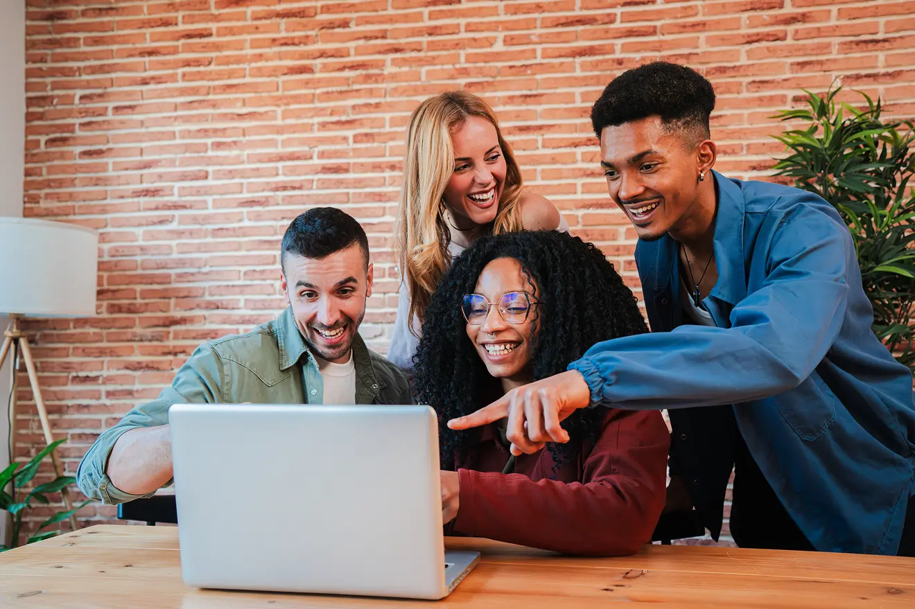 Friends happily looking at a computer